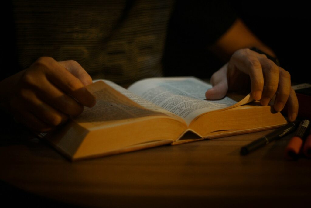 a person is reading a book on a table