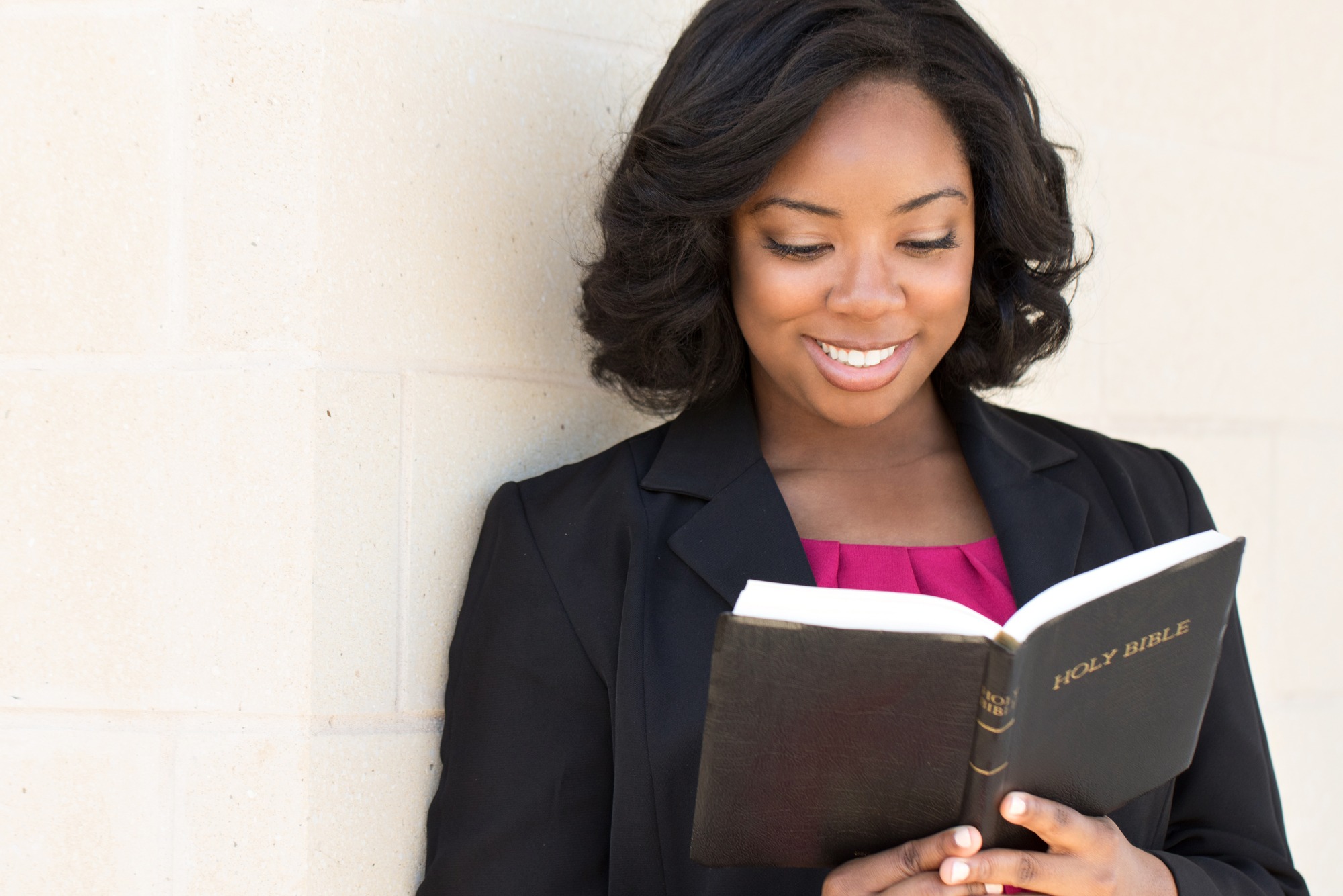 African American woman reading The Bible